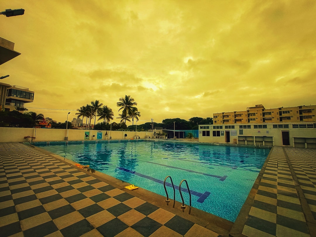 a swimming pool with buildings in the background