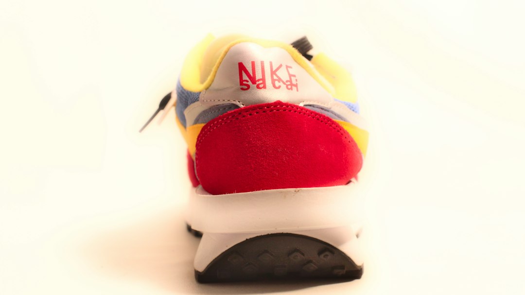 A shoe with a red, white, and blue shoelace