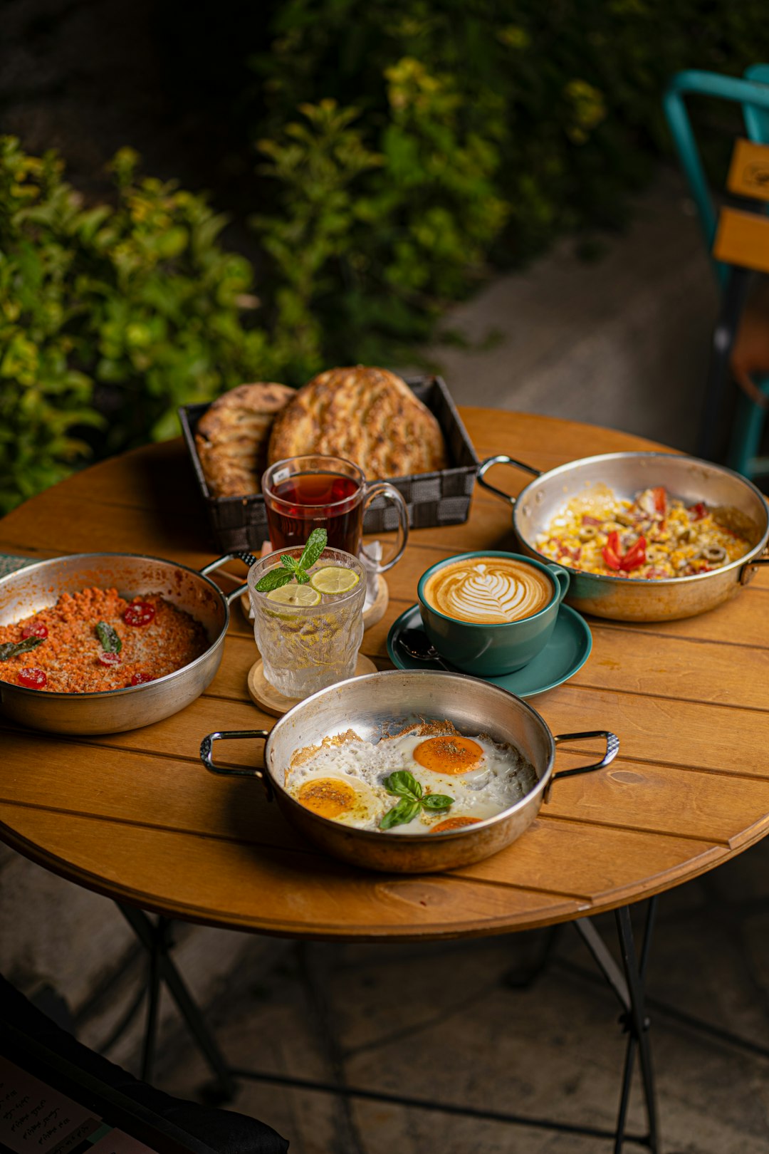 A table laden with breakfast dishes, tea, and coffee