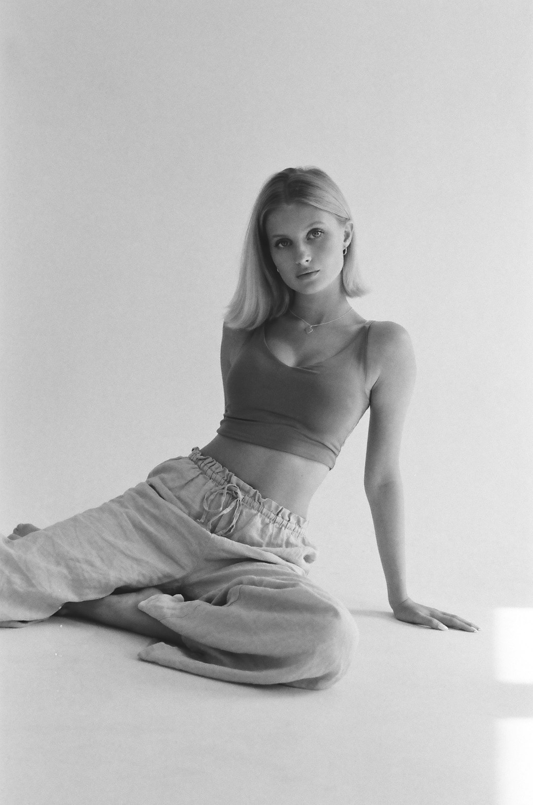 A young woman sitting on the floor in a studio