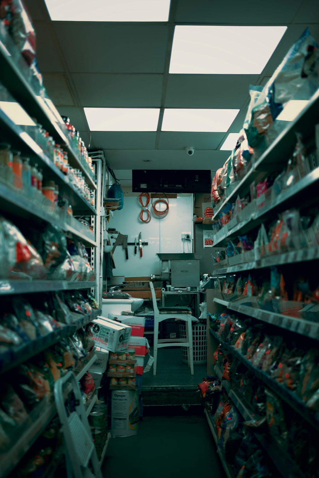 Aisle of a convenience store stocked with goods