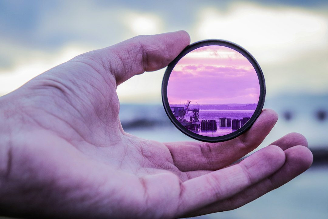 person holding lens